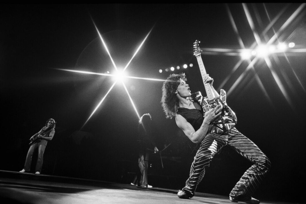 Van Halen-Eddie performing playing guitar with star lights in background LOS ANGELES, 1979